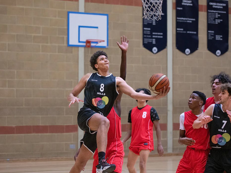 A Basketball player jumping to attempt to score